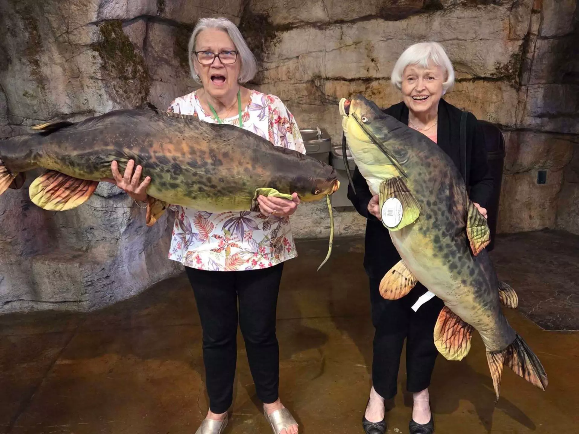 StoryPoint Germantown residents pose with large faux fish at Bass Pro Shop.