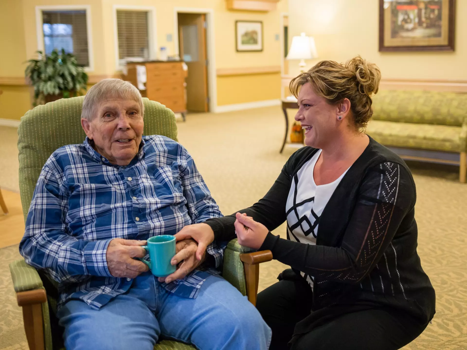 Senior on couch with coffee