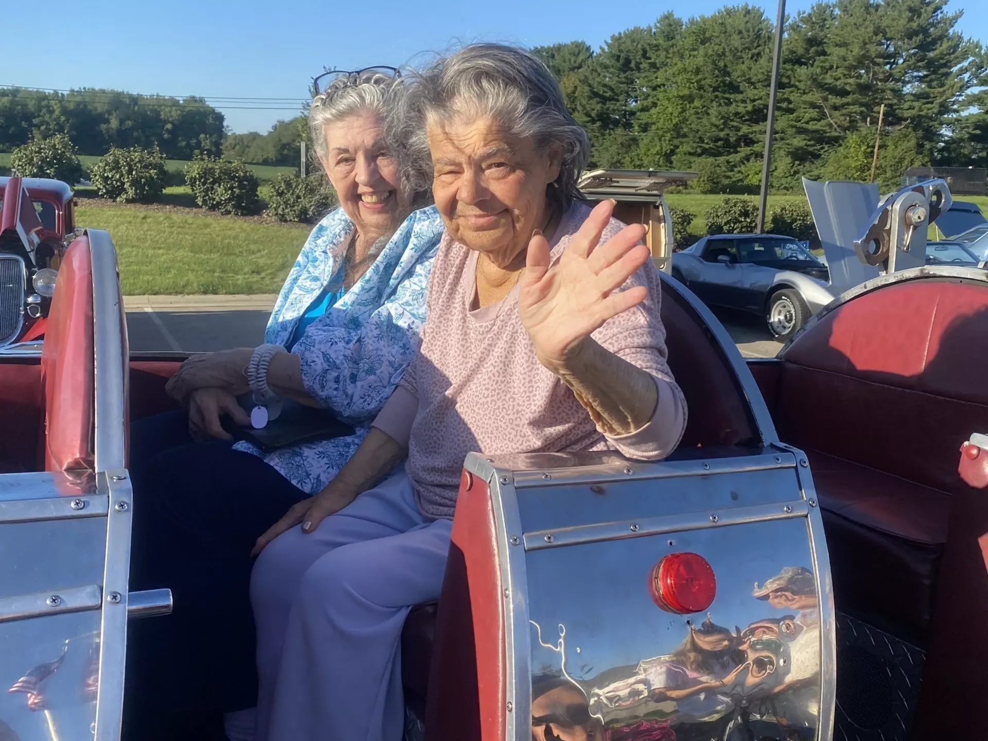 Two StoryPoint Group residents are riding in a trolly cart.