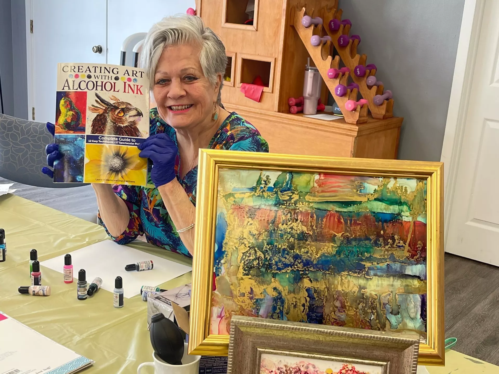 A senior woman creating art with alcohol ink.